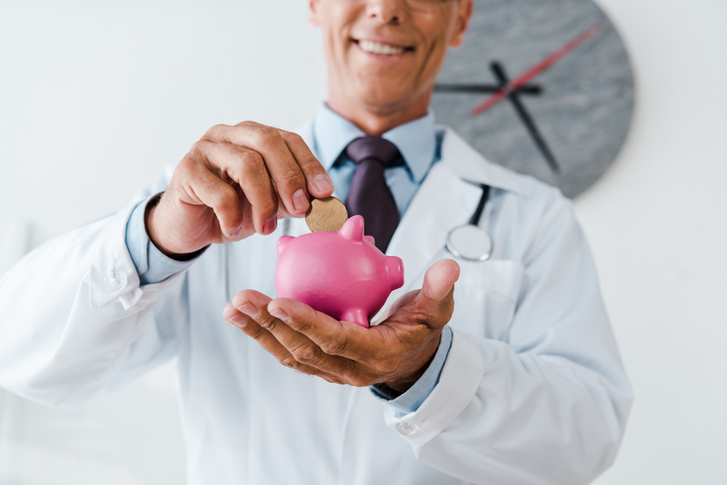 cropped-view-of-happy-doctor-in-white-coat-putting-2024-11-13-10-21-55-utc-1