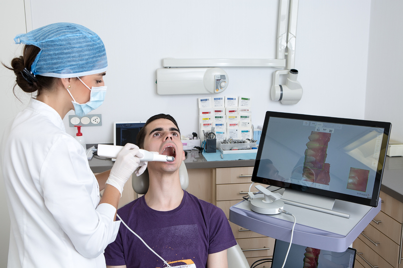 dentist-making-3d-scan-of-client-teeth-2025-03-09-17-04-38-utc-1